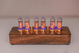 Six-tube IN-14 Nixie clock in solid walnut with brass rings, tubes glowing, showing 15:12:28