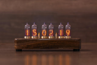 IN-14 Nixie clock with six glowing tubes on a dark wooden desk