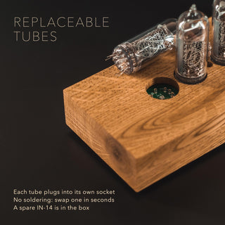 Replaceable IN-14 Nixie tube lifted out of its socket in the solid ash block case, no soldering needed