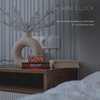 IN-14 Nixie tube clock as an alarm clock on a bedside table, showing 12:55