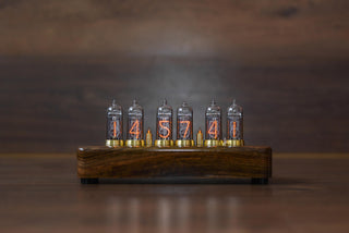 Six-tube IN-14 Nixie clock in a dim room, tubes glowing softly