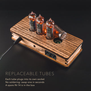 Replaceable IN-14 Nixie tube lifted out of its socket in the vintage olive ash case with the Nixie Star badge, no soldering needed